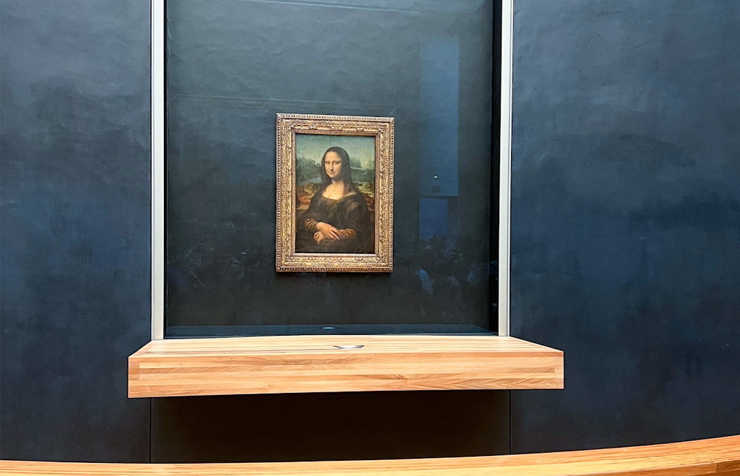 Guide leading tourists through the Louvre Museum, Paris, showcasing famous artworks on a 3-hour tour.