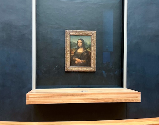 Guide leading tourists through the Louvre Museum, Paris, showcasing famous artworks on a 3-hour tour.