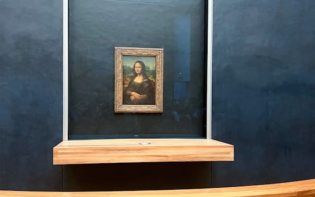Mona Lisa displayed at the Louvre Museum in Paris during a guided tour.