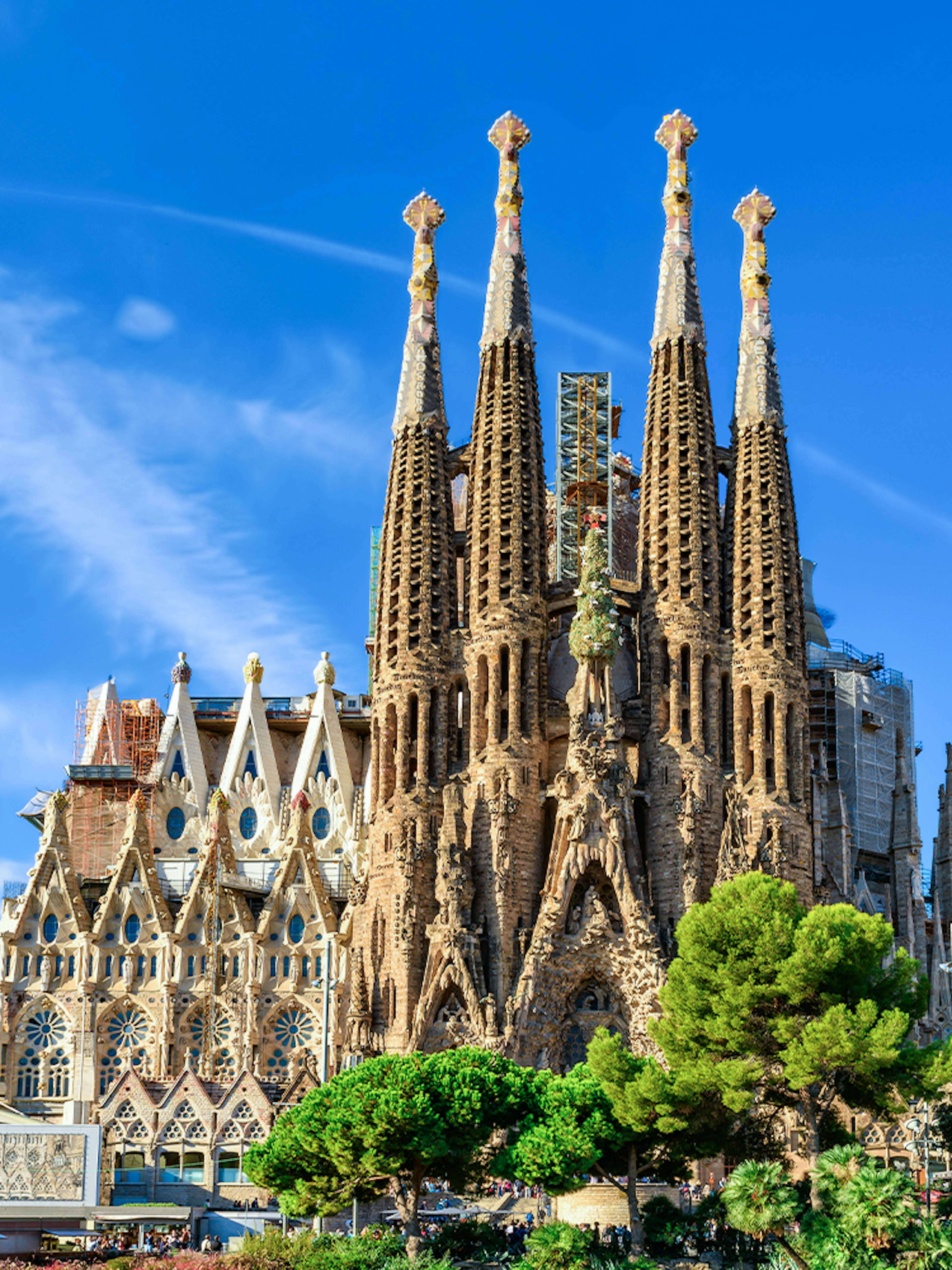 Sagrada Familia basilica with spires against blue sky, Barcelona.