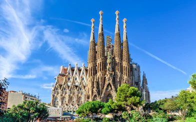 Sagrada Familia basilica with spires against blue sky, Barcelona.