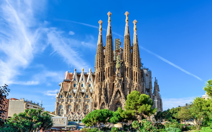 Sagrada Familia basilica with spires against blue sky, Barcelona.