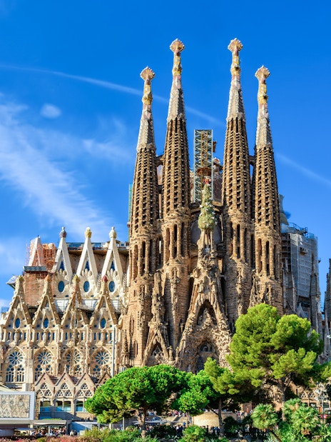Sagrada Familia basilica with spires against blue sky, Barcelona.