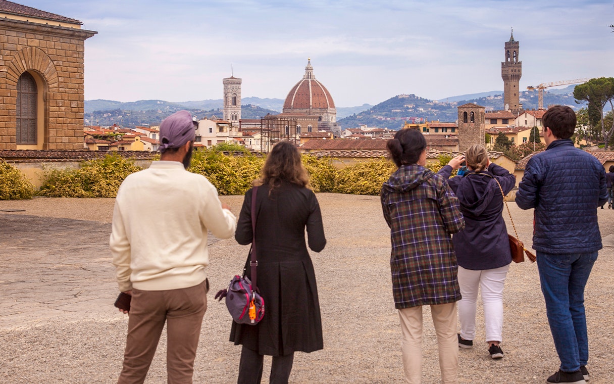 Visitors enjoying a view of Florence's skyline from Boboli Gardens, featuring the Duomo and Palazzo Vecchio.