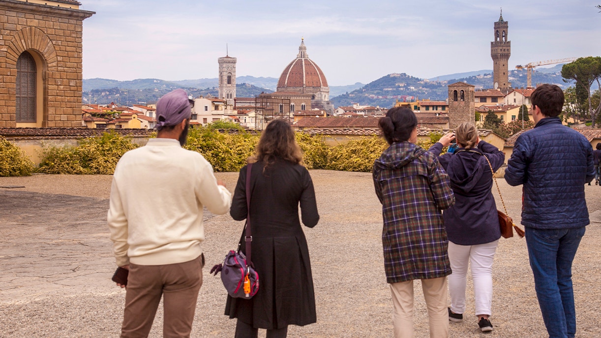 Visitors enjoying a view of Florence's skyline from Boboli Gardens, featuring the Duomo and Palazzo Vecchio.