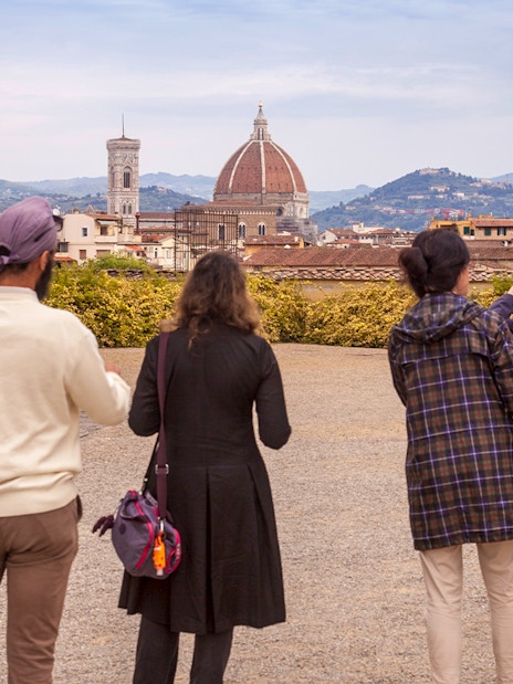 Visitors enjoying a view of Florence's skyline from Boboli Gardens, featuring the Duomo and Palazzo Vecchio.
