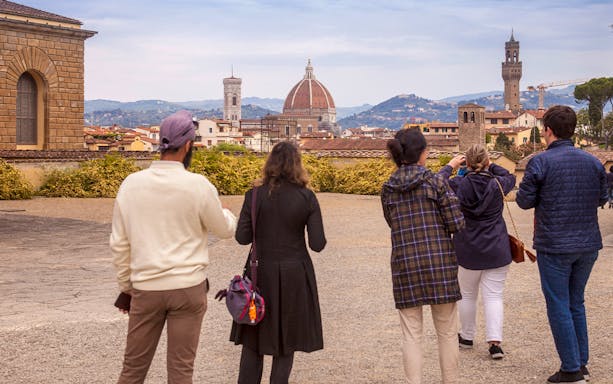 Visitors enjoying a view of Florence's skyline from Boboli Gardens, featuring the Duomo and Palazzo Vecchio.