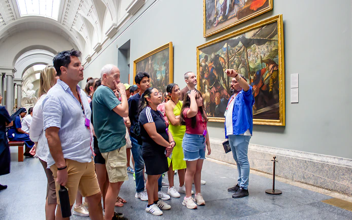 Visitors on a guided tour viewing paintings at Prado Museum, Madrid.