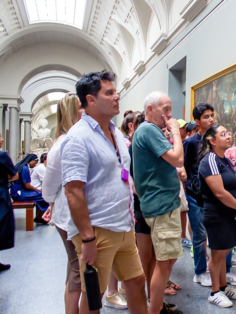Visitors on a guided tour viewing paintings at Prado Museum, Madrid.