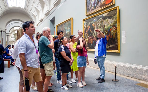 Visitors on a guided tour viewing paintings at Prado Museum, Madrid.