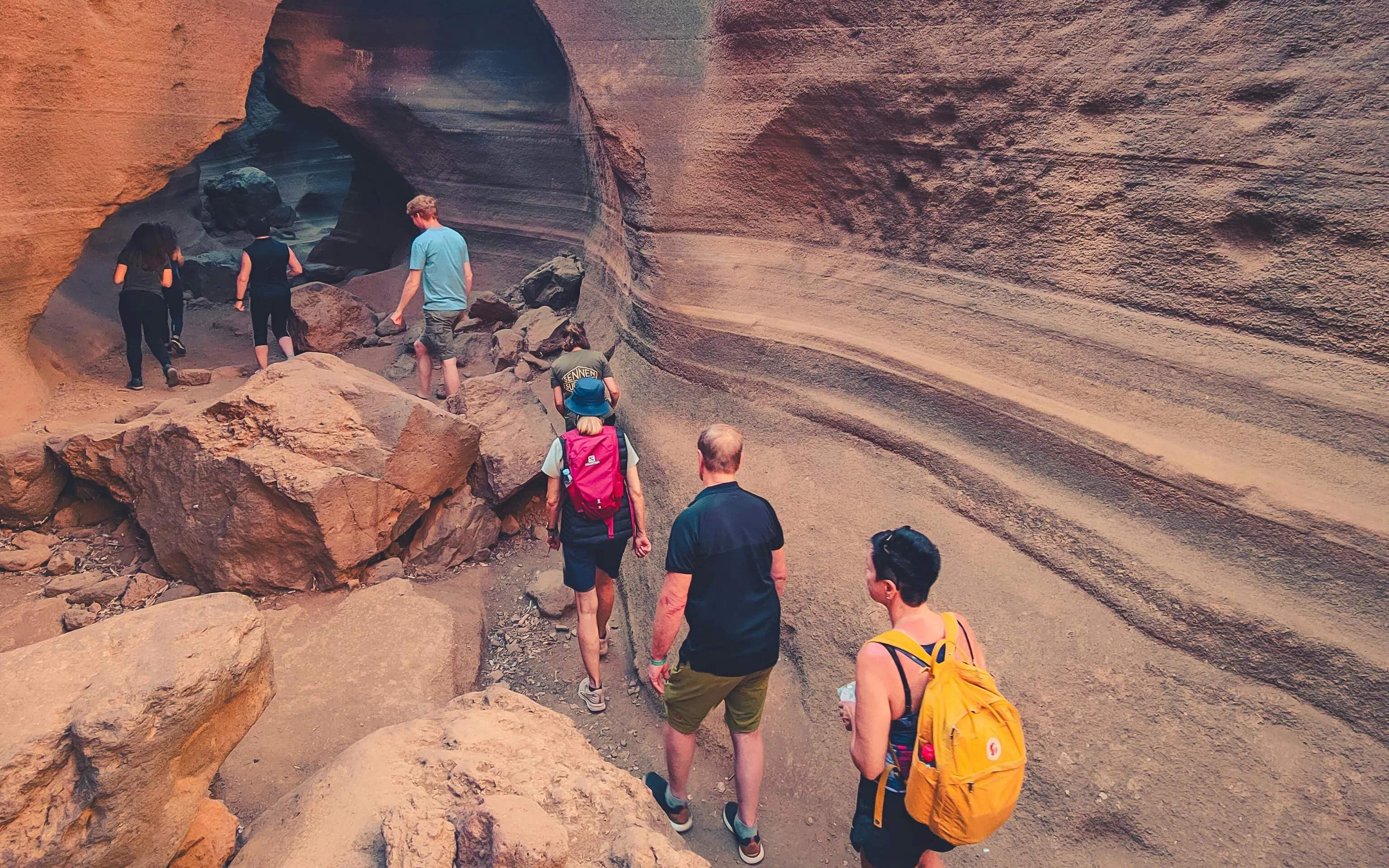 Hikers exploring Red Canyon's rock formations in Gran Canaria.