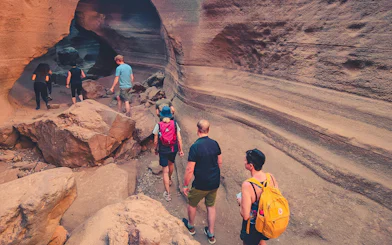 Hikers exploring Red Canyon's rock formations in Gran Canaria.