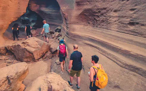 Hikers exploring Red Canyon's rock formations in Gran Canaria.