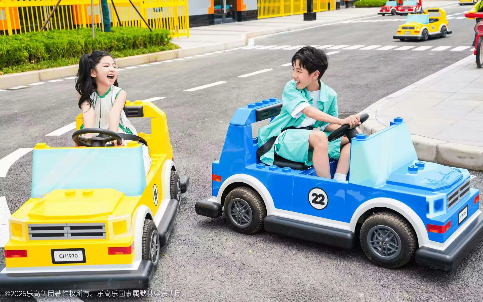 Children driving toy cars at Legoland Shanghai's Driving School attraction.