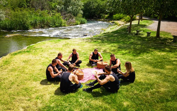 Group enjoying a picnic by a river during a Canoe Safari tour from Split.