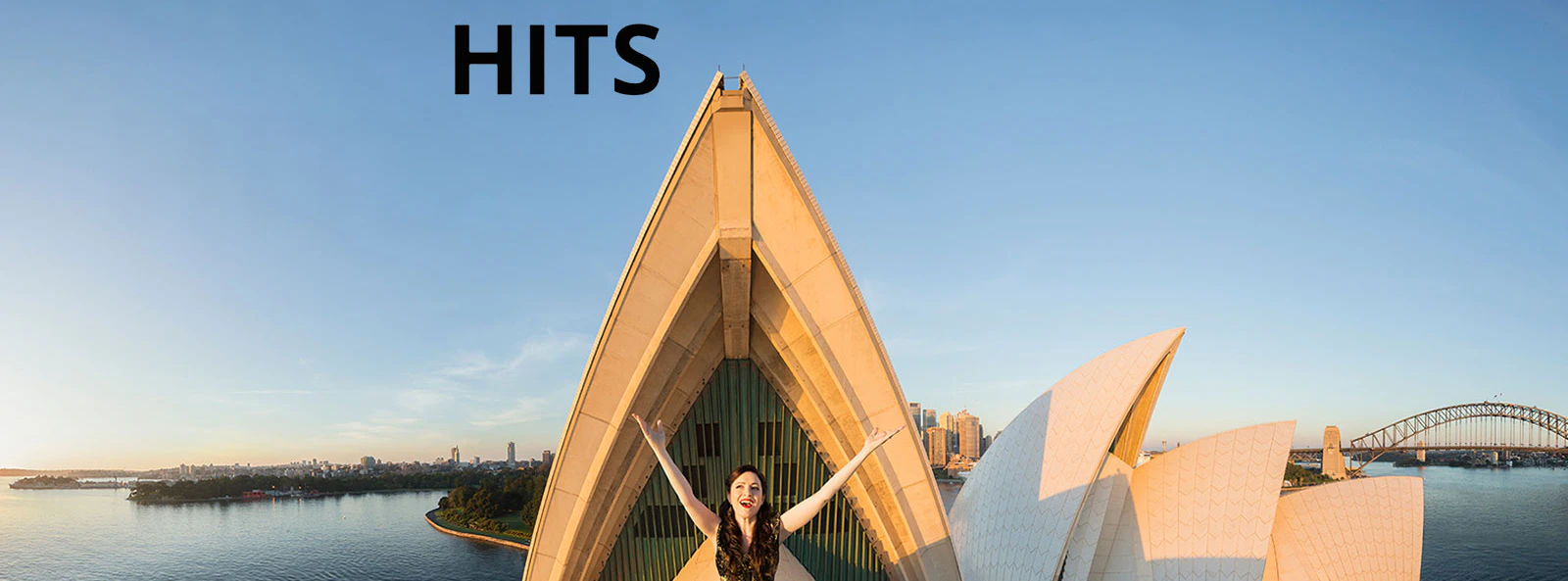 Opera singer on Sydney Opera House roof with city skyline, Great Opera Hits 2025.