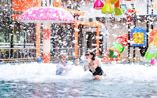 Children playing in foam at Rawai Kids Park water area.