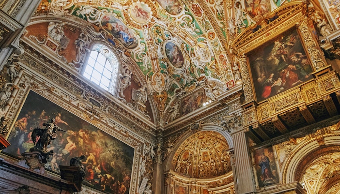 Santa Maria Maggiore Basilica interior with ornate frescoes and detailed ceiling art.