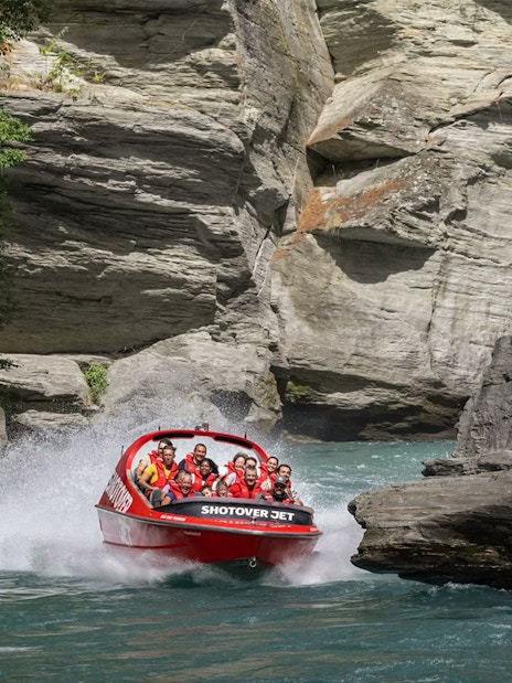 Shotover Jet navigating through narrow canyon in New Zealand.