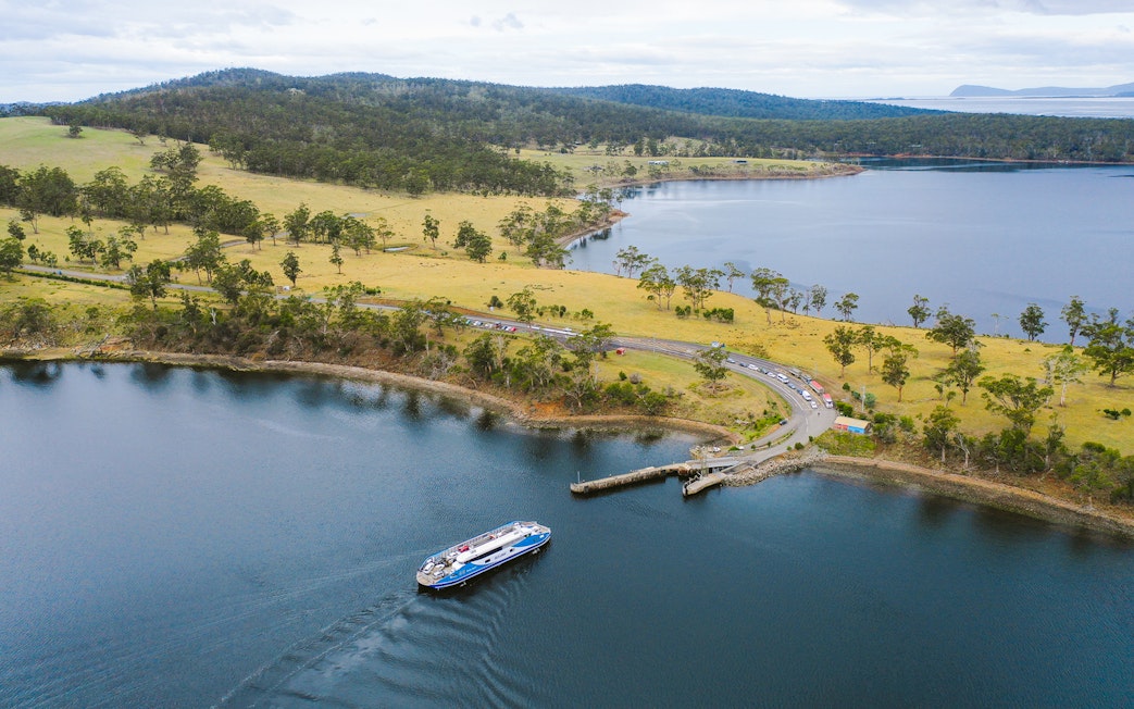Bruny Island coastline with ferry approaching dock, part of Hobart full-day guided tour.