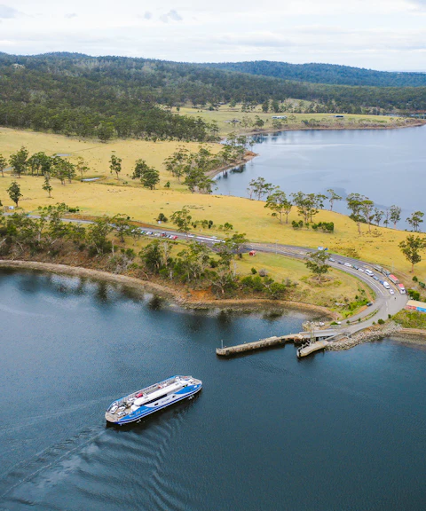 Bruny Island coastline with ferry approaching dock, part of Hobart full-day guided tour.