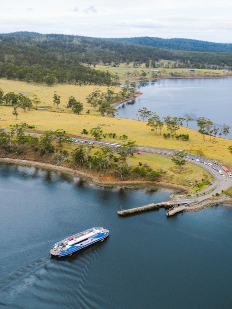 Bruny Island coastline with ferry approaching dock, part of Hobart full-day guided tour.