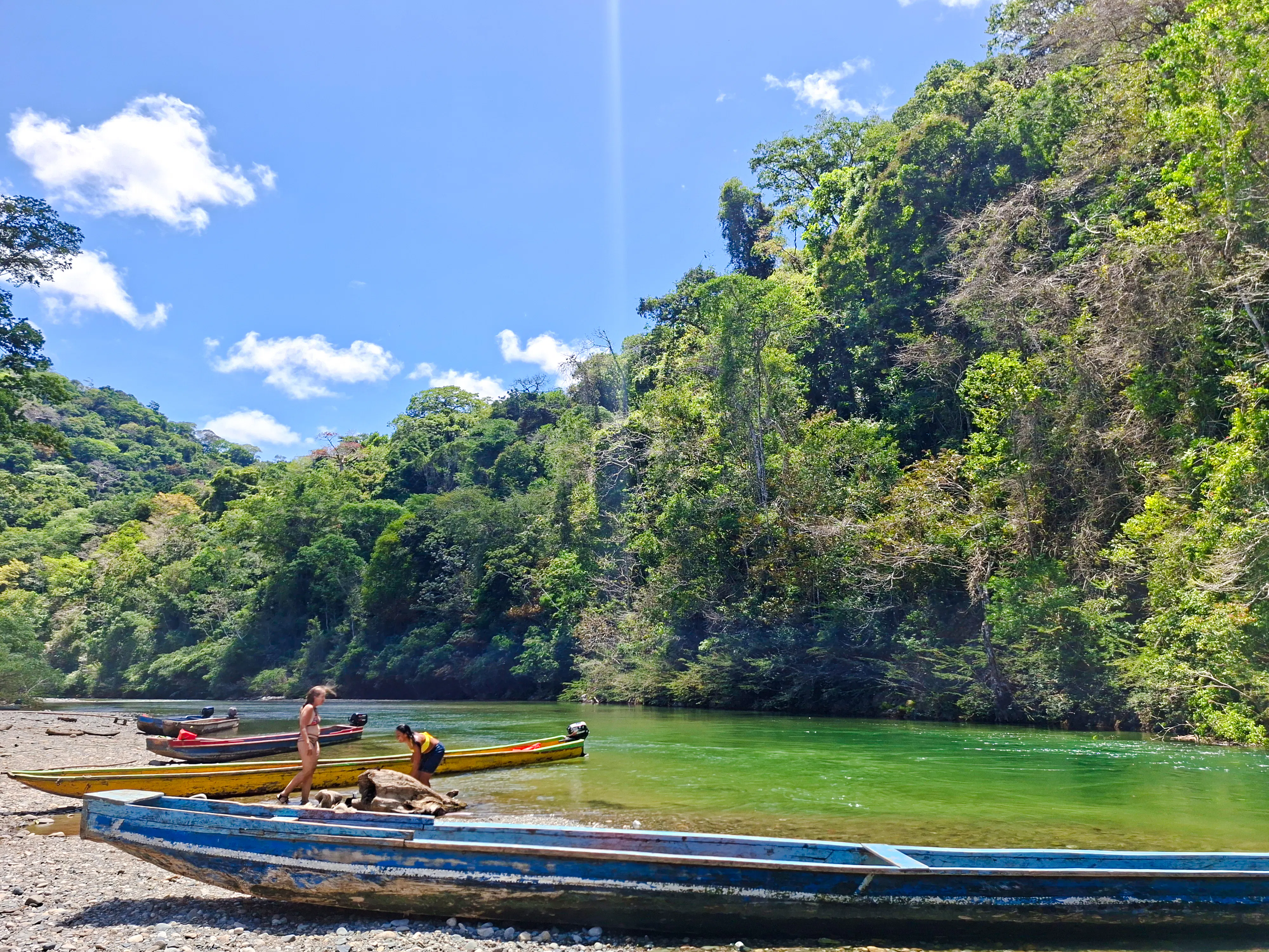 Boats on the riverbank with lush jungle backdrop, Monke Island & Emberá Community, Panama City.