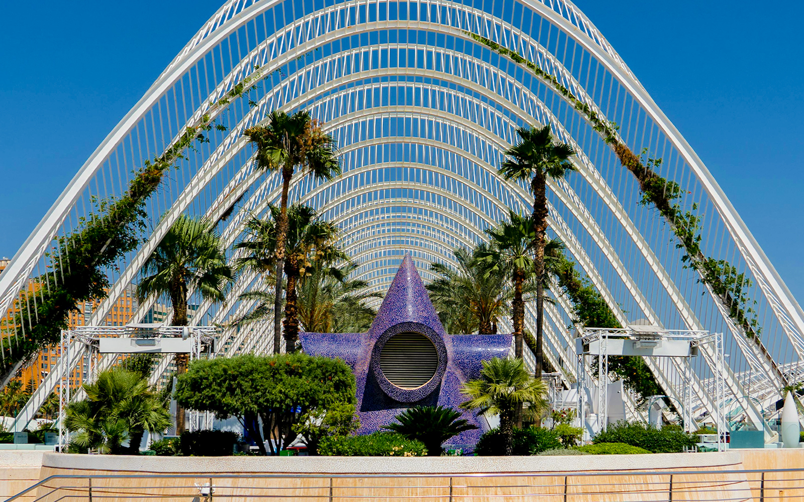 Hemisfèric architecture with palm trees and pool in City of Arts and Sciences, Valencia.