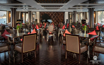Luxurious dining area on Ha Long Bay 5-Star Ambassador Cruise with elegant seating and scenic views.