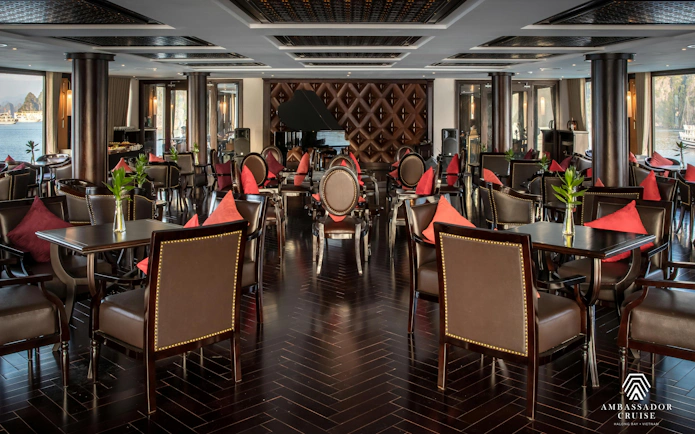 Luxurious dining area on Ha Long Bay 5-Star Ambassador Cruise with elegant seating and scenic views.
