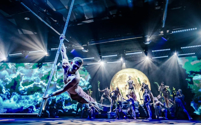 Aerial performer on stage at Sala Scala Gran Canaria with moon backdrop.