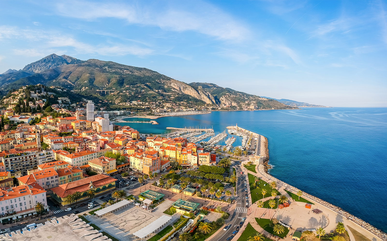 Aerial view of Nice coastline with marina and colorful buildings, France.