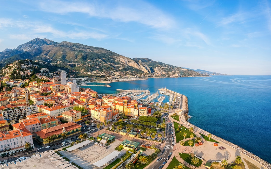Aerial view of Nice coastline with marina and colorful buildings, France.