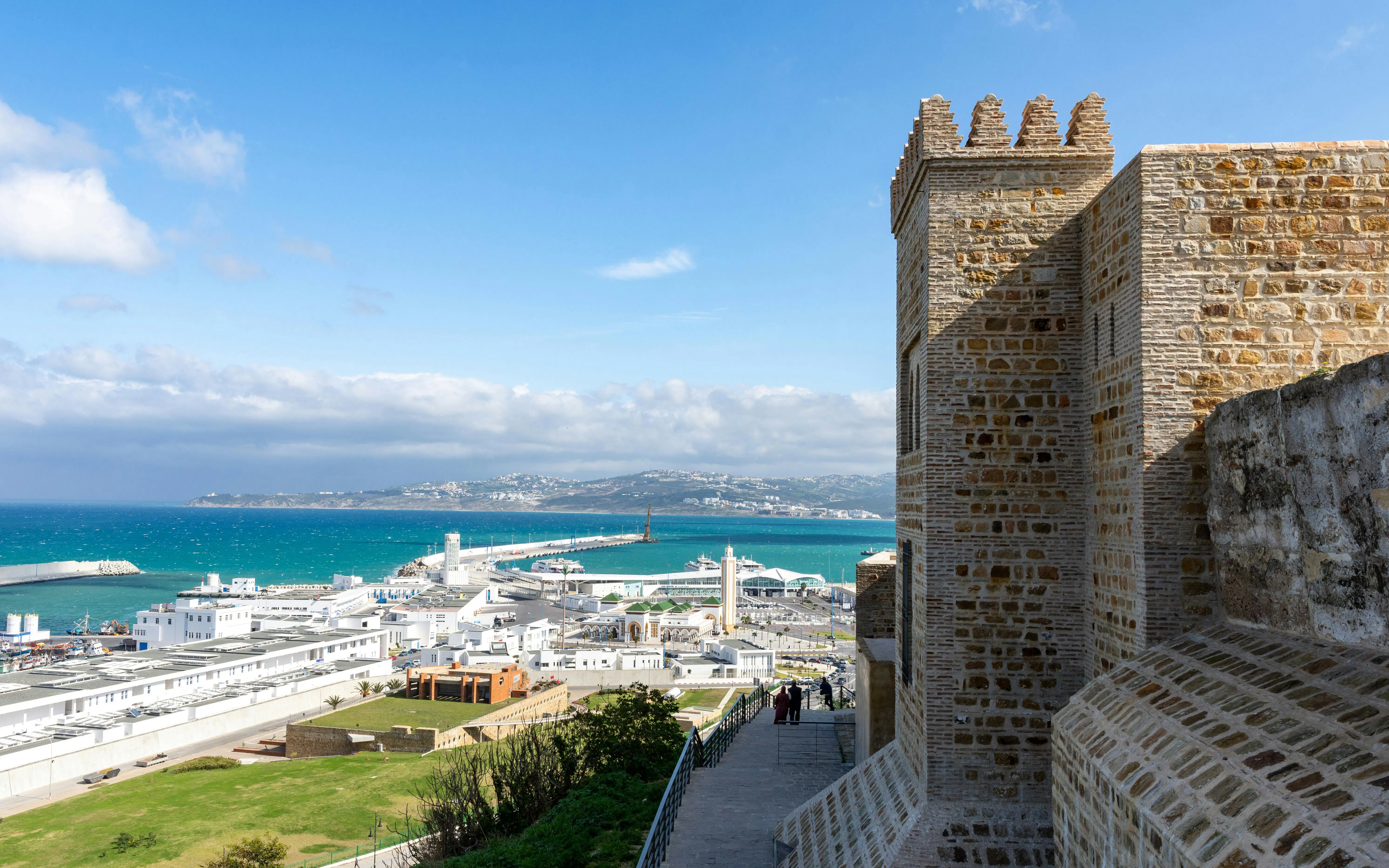Tangier's Kasbah overlooking the harbor and cityscape with distant hills.