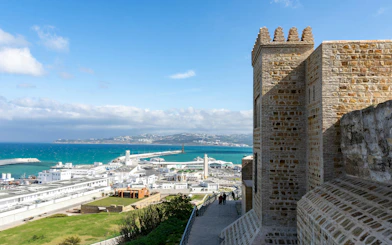 Tangier's Kasbah overlooking the harbor and cityscape with distant hills.