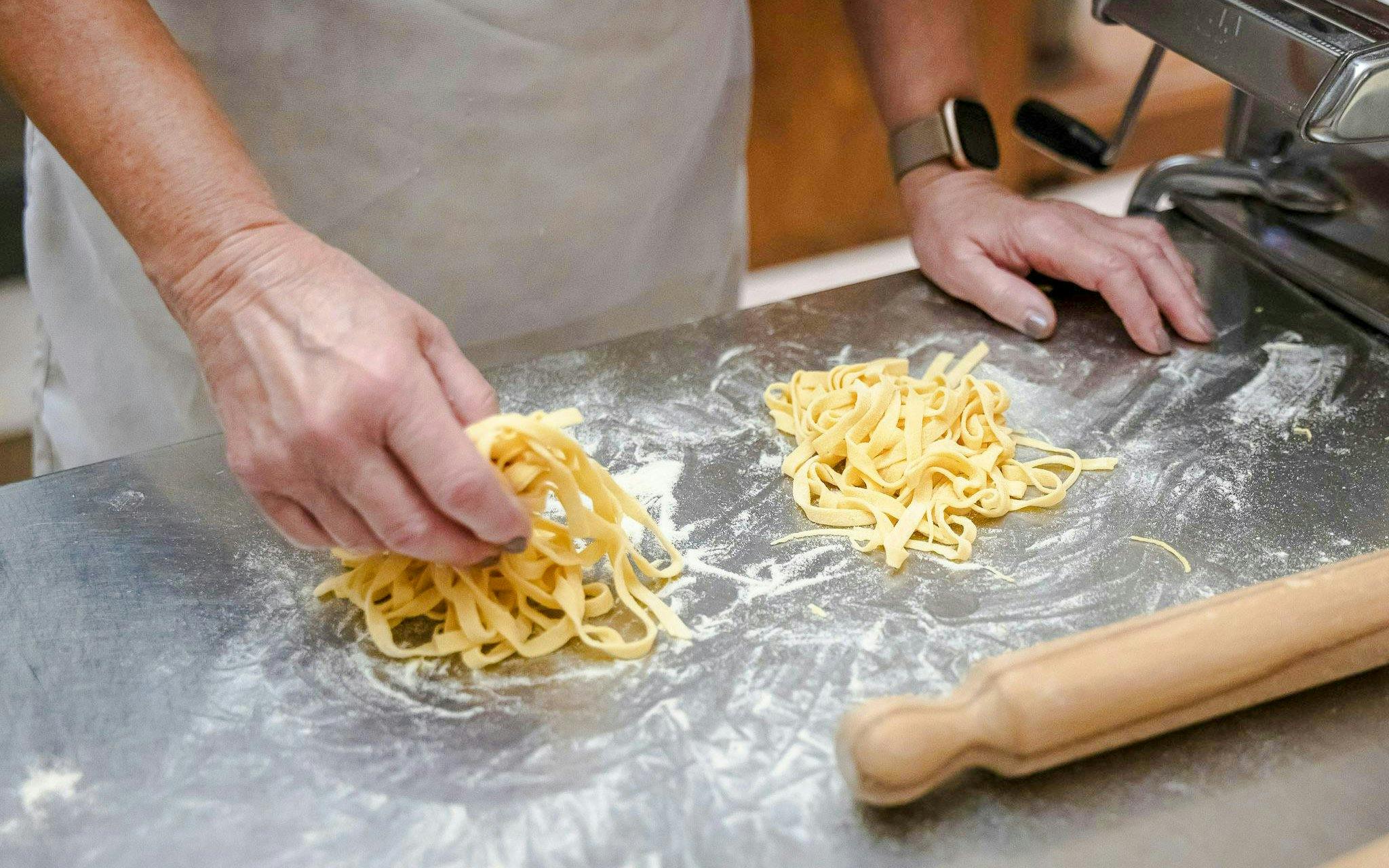 Hand shaping fresh pasta during a Florence cooking class.