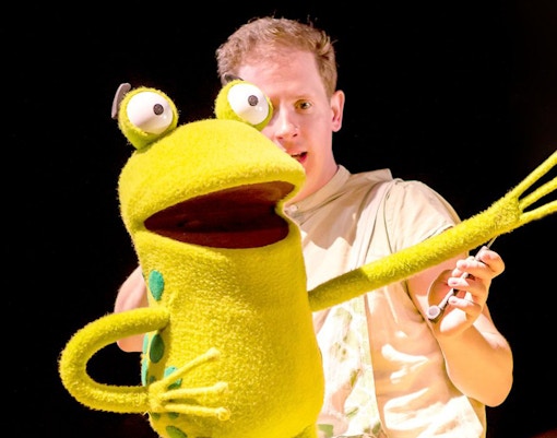 Puppeteer with frog puppet from "Oi Frog & Friends!" show.