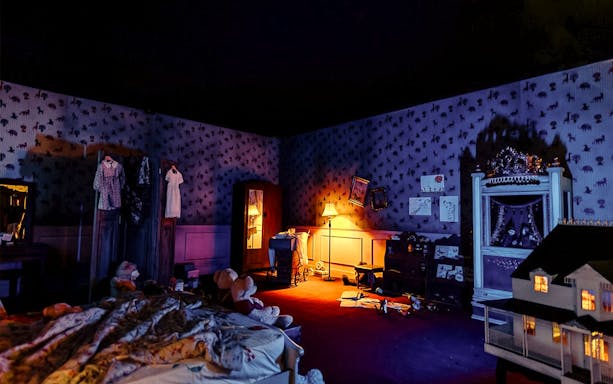 Dimly lit room with vintage decor and toys, part of The Conjuring Universe Tour in Malaysia.