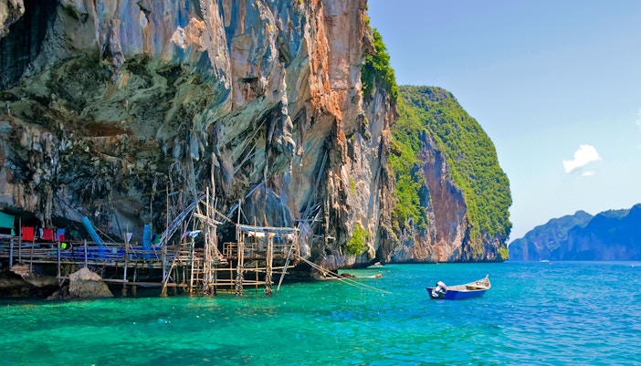 Viking Cave on Ko Phi Phi, Thailand, with turquoise waters and limestone cliffs.
