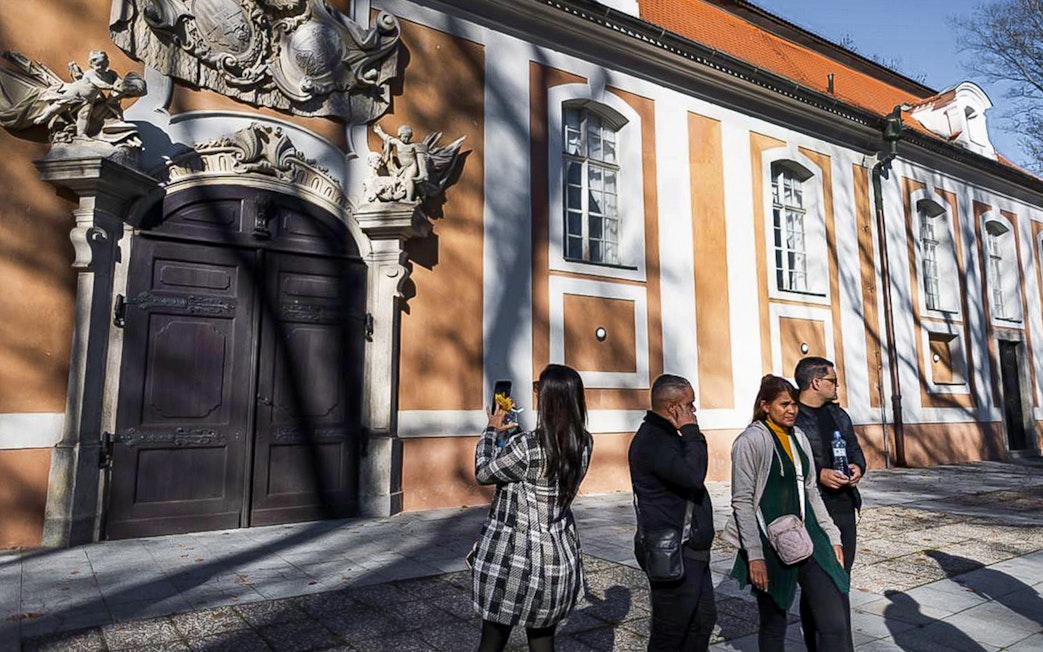 Tourists outside a historic building in Cesky Krumlov during a guided tour.