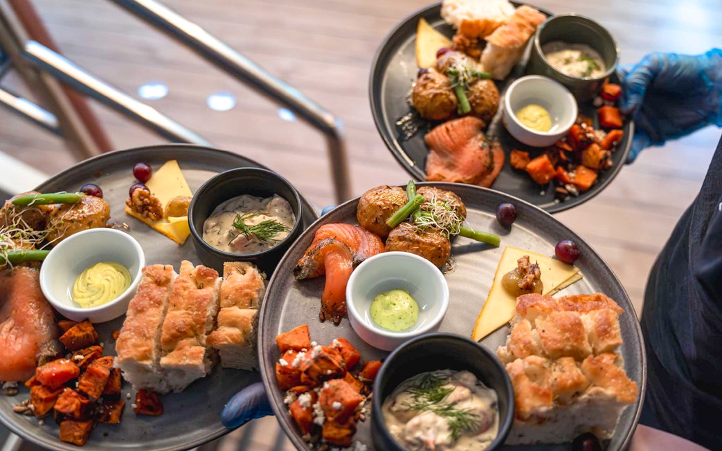 Gourmet dishes served on a dinner cruise, featuring salmon, potatoes, and bread.