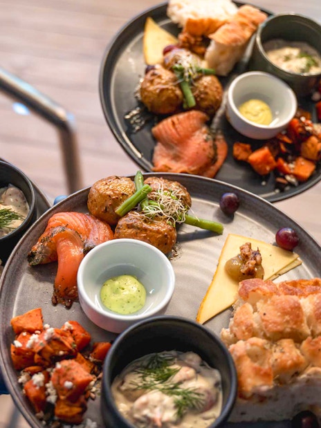 Gourmet dishes served on a dinner cruise, featuring salmon, potatoes, and bread.