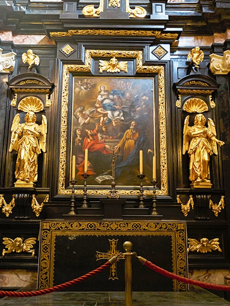 Wawel Cathedral interior with ornate altar and religious artwork.