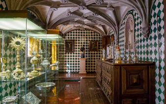 Sintra palace interior with religious artifacts and ornate ceiling.