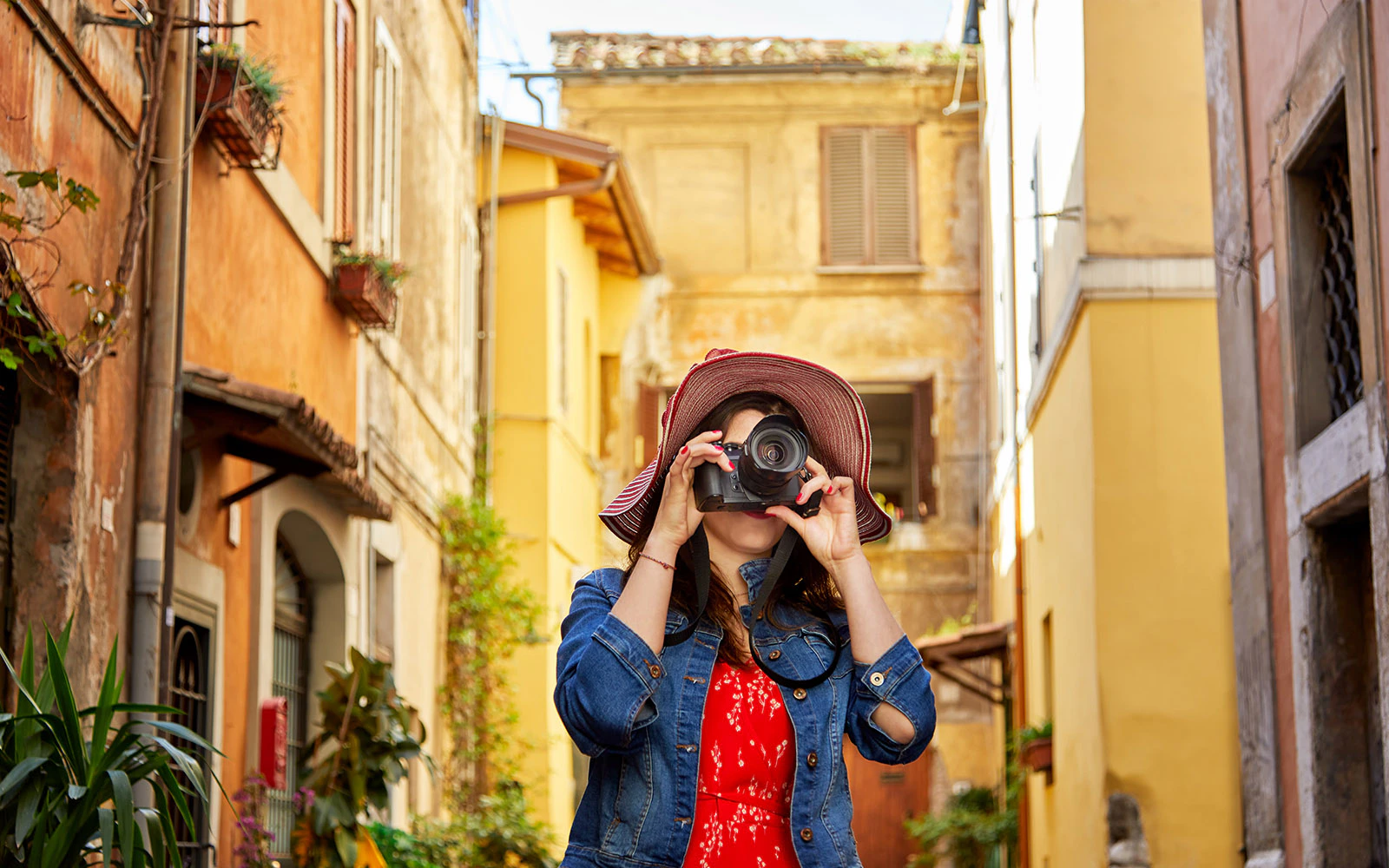 Photographer exploring charming streets of Trastevere, Rome.
