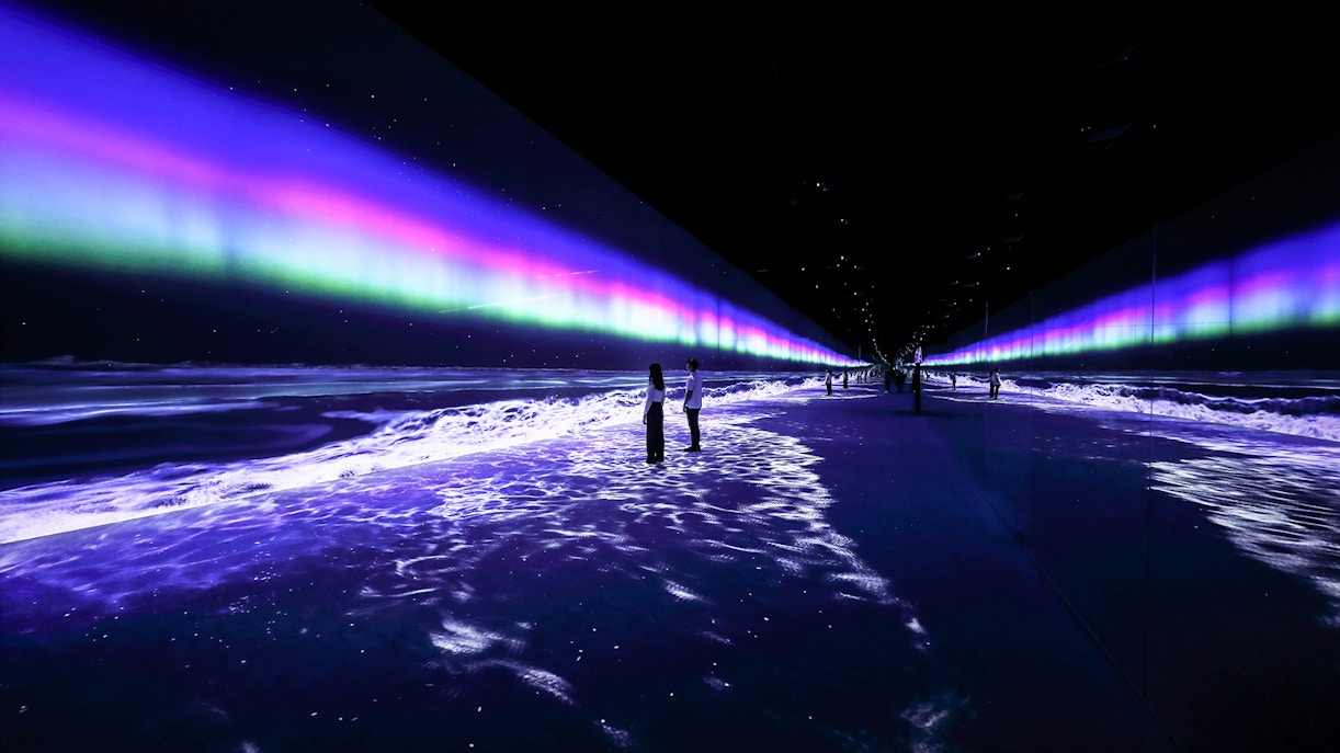 Immersive light display at ARTE Museum Dubai with visitors walking through.