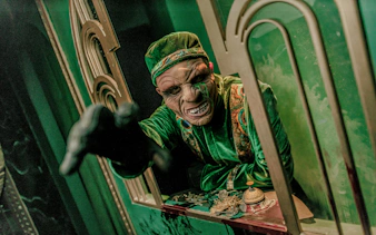 Actor in costume reaching out at Knott's Berry Scary Farm, Southern California.