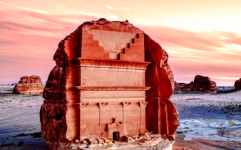 Ancient rock-cut tomb at AlUla, Saudi Arabia, during sunset on a private tour from Medina.