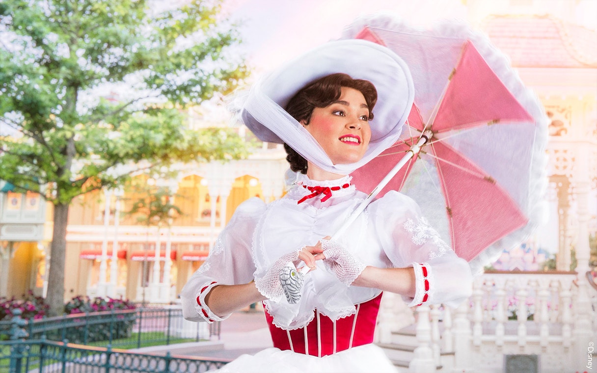 Character in Victorian attire with parasol at Disneyland Paris.