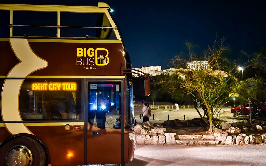 Big Bus Athens night tour with Acropolis view in the background.
